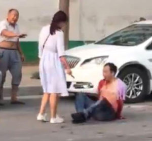 Photos/video: Woman stabs 'cheating husband' with knife in front of passers-by