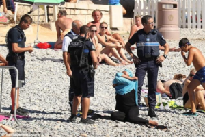 French police force Muslim woman to remove her Burkini on Nice beach (photos)
