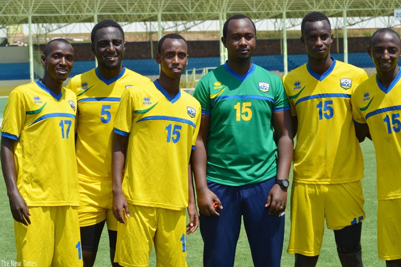 Newly appointed Amavubi interim assistant coach Mashami and some players take a break from training to poses for the cameras at Kigali Regional Stadium 