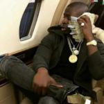 Photos of son of incoming President of Zimbabwe flaunting cash and luxury car on social media