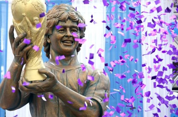 Diego Maradona unveils 12ft statue of himself holding World Cup in India... but its dodgy likeness risks ridicule