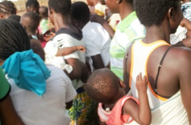 Frustrated single mothers feeding hungry babies with Akpeteshie