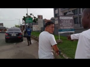 VIDEO: Chinese man living in Ghana ordered to pick trash from gutter after he was caught littering