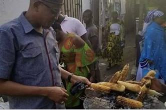 PHOTO: Mustapha Hamid buys roasted corn at Nima
