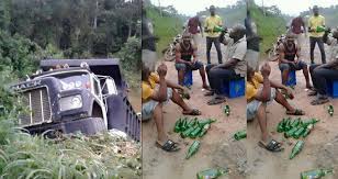 Men celebrate with bottles of beer in the middle of the road after surviving truck accident