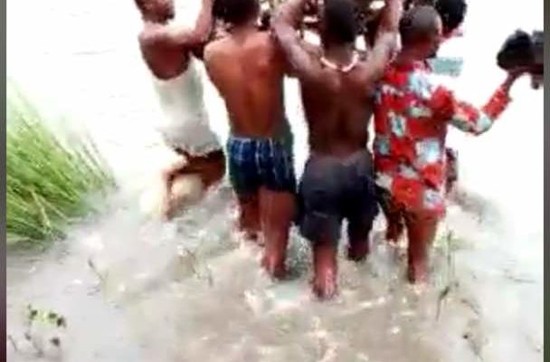 Angry Ghanaians react to video of woman in labor carried across a river to a Hospital