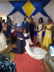 TOUCHING PHOTOS: Man kneels down to kiss his Dwarf-like Lover on their wedding day