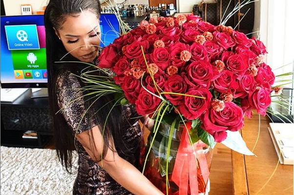 Emmanuel Adebayor surprises his girlfriend Dillish Mathews with giant bouquet of red roses on Valentine's Day