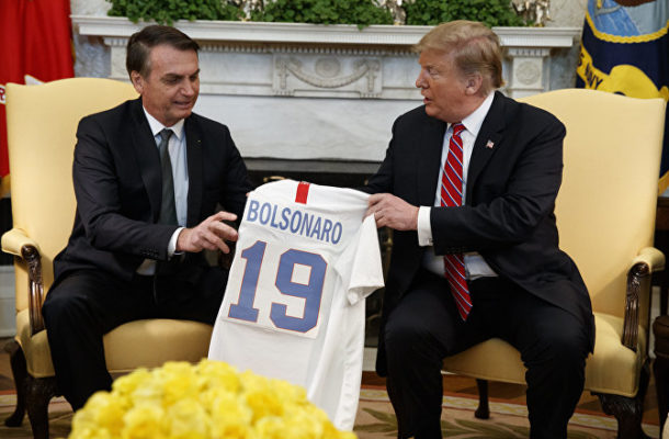 Trump Jeered at as He Gifts Brazil’s Bolsonaro Tacky 'Homemade' Football Jersey