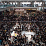 Thousands of protesters shut down Hong Kong airport as Beijing condemns 'terrorism'