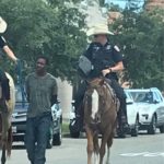 Texas police apologise for horseback officers leading black man by rope