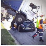 Woman survives after lorry lands on her car