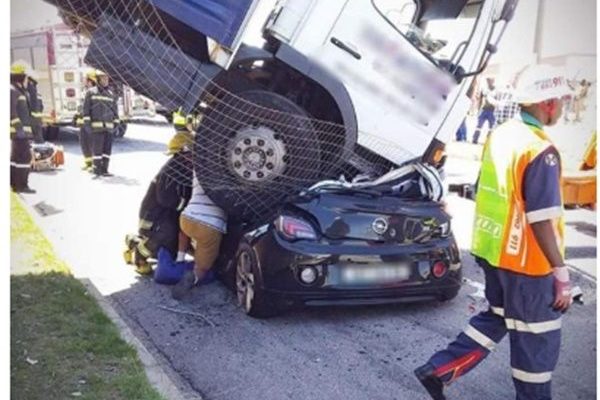 Woman survives after lorry lands on her car