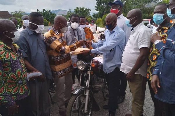 Dr. Adu-Ampomah presenting the motorbikes to the Eastern regional branch of the NPP