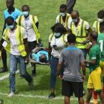 Referee Charles Bulu responding to treatment after collapsing during AFCON qualifier