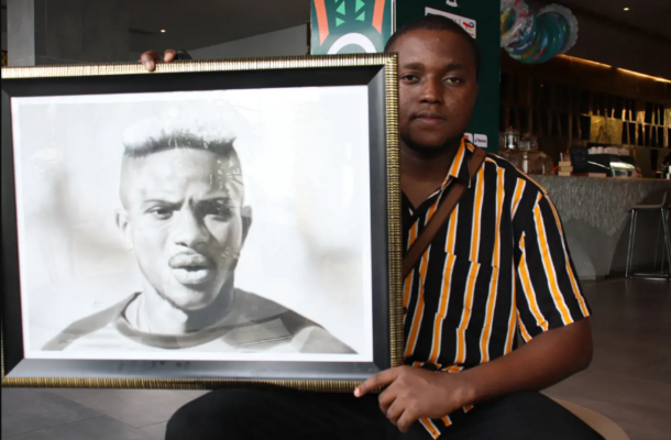 Artists presents Victor Osimhen painting to him at Super Eagles camp